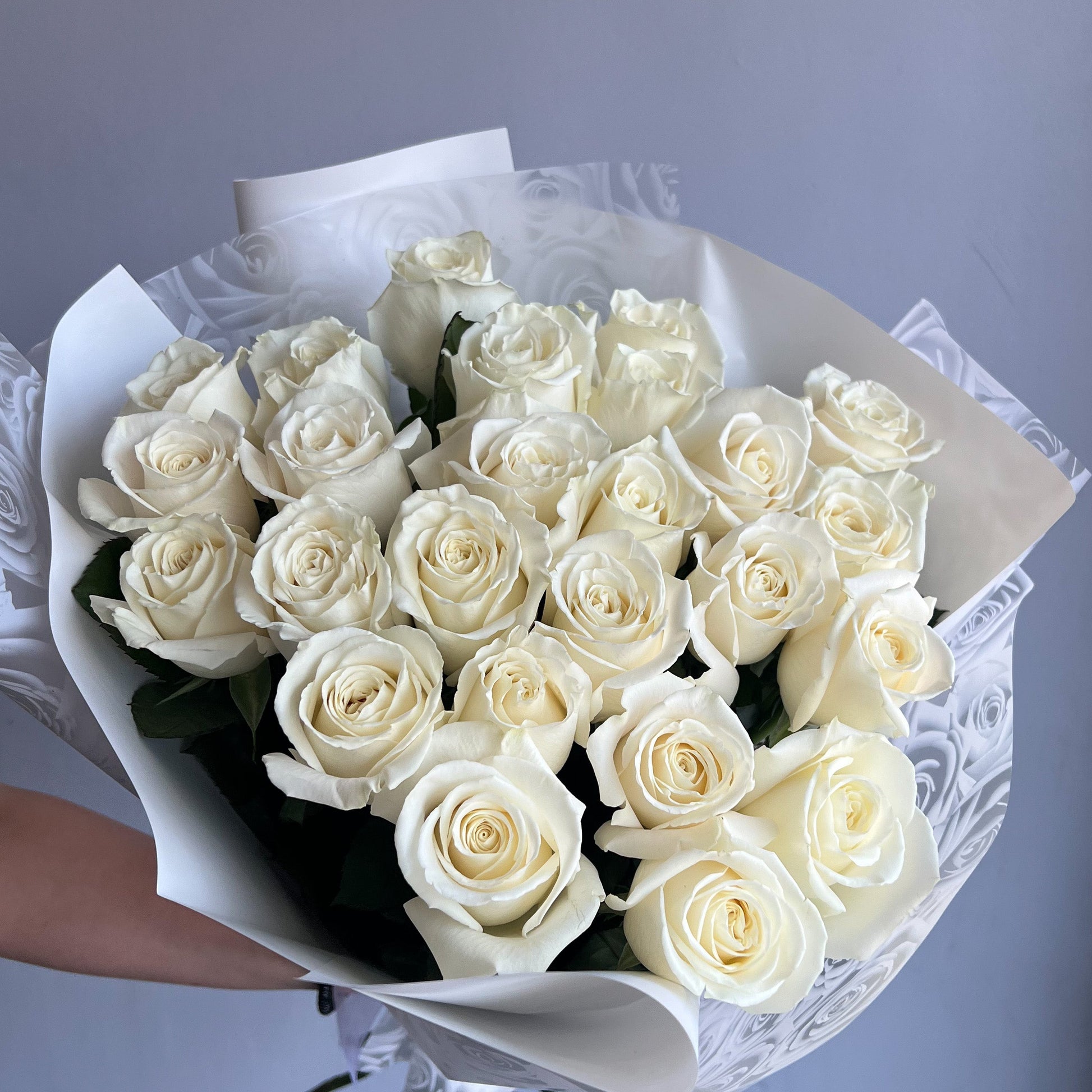 A delicate bouquet of white roses, showcasing their elegance and beauty.
