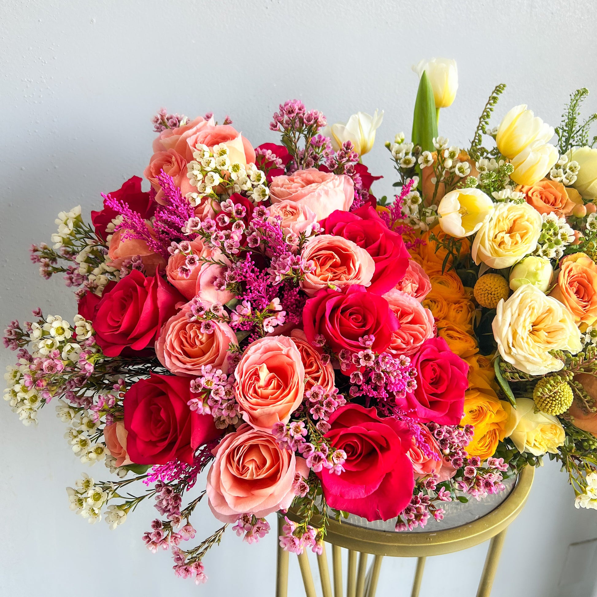 Two bouquets of flowers, titled 'Rosy Radiance', elegantly arranged on a table.