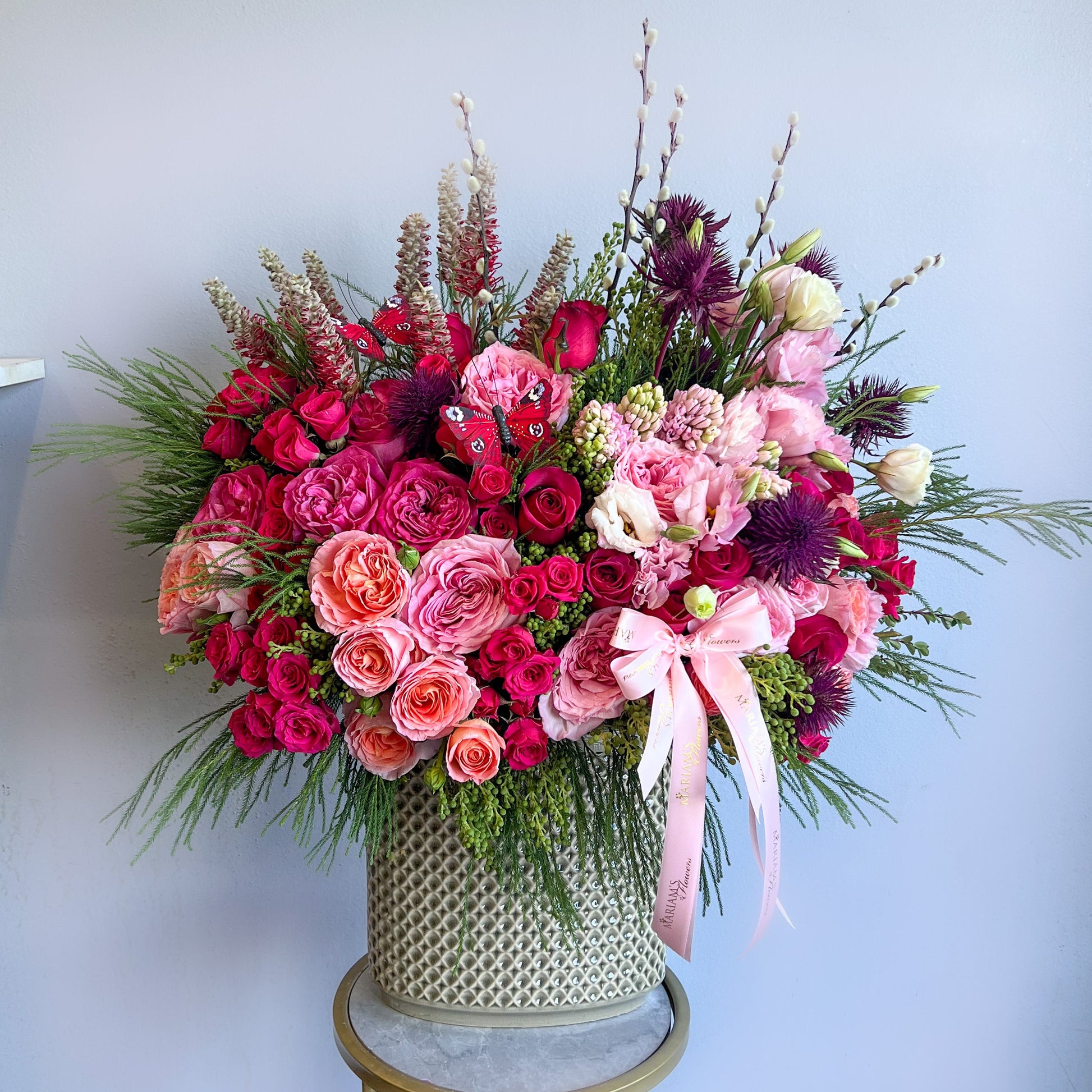 Elegant vase brimming with pink and purple flowers, part of the Butterfly Bloom flower arrangements collection