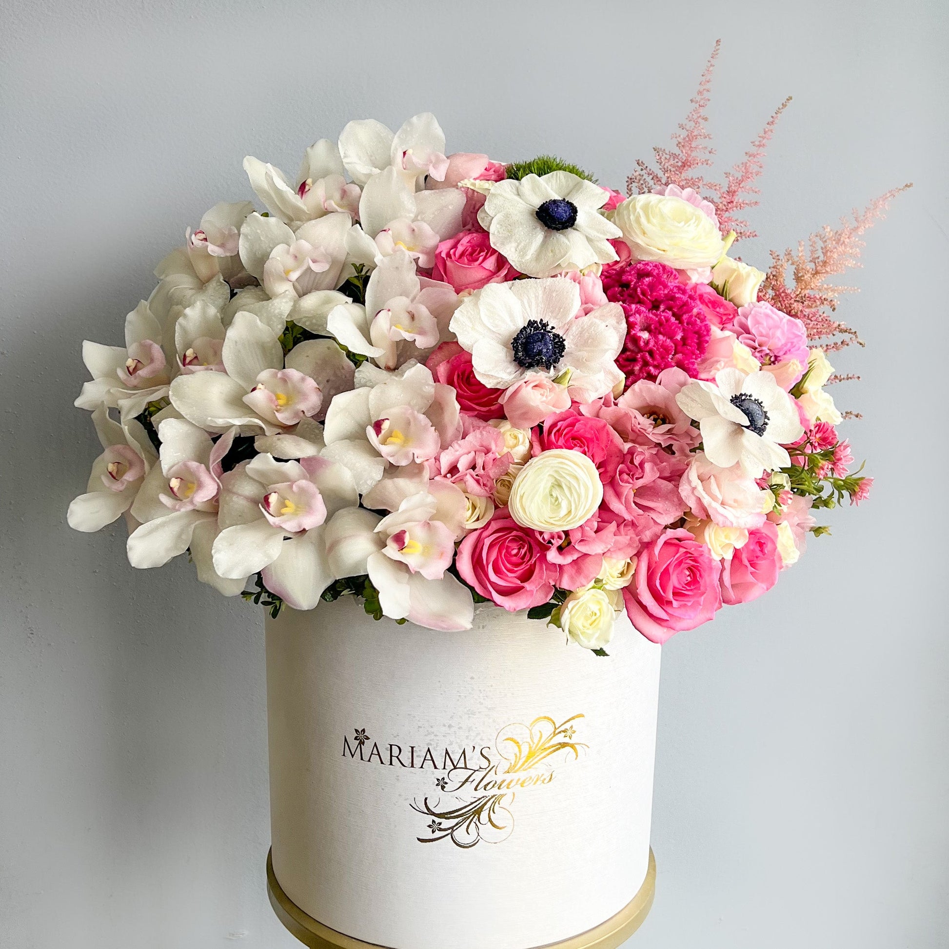 A white box adorned with a charming mix of pink and white flowers, perfect for any floral arrangement setting