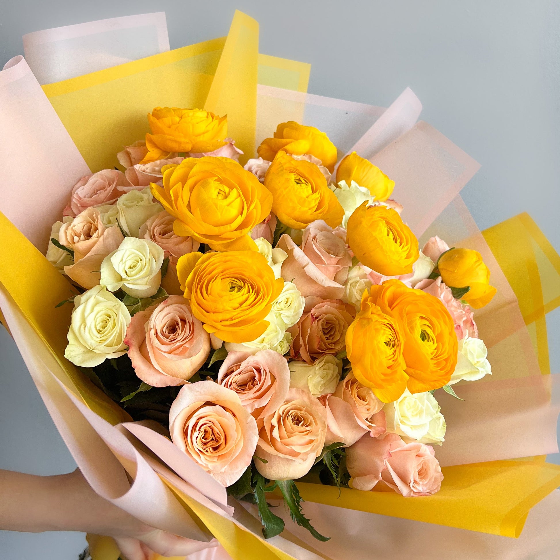 a bouquet of pink and yellow roses, showcasing their vibrant colors and delicate petals.